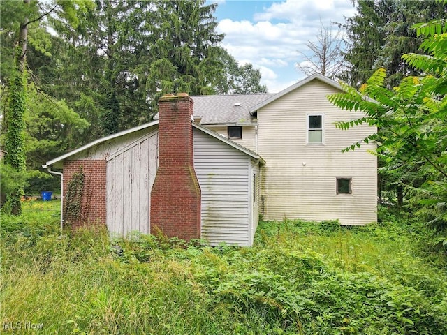 1811 Randolph Rd, Mogadore, OH 44260 - back of house featuring a chimney and a shingled roof