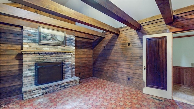 1811 Randolph Rd, Mogadore, OH 44260 - unfurnished living room featuring wooden walls, beam ceiling, and a brick fireplace