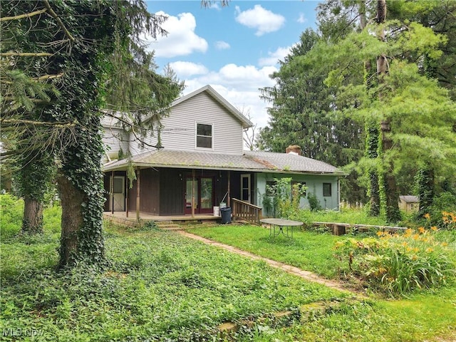 1811 Randolph Rd, Mogadore, OH 44260 - view of front facade featuring a chimney and a front lawn