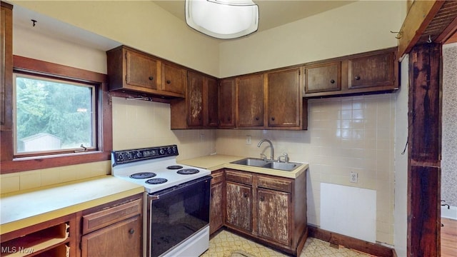 1811 Randolph Rd, Mogadore, OH 44260 - kitchen with electric range, light countertops, and decorative backsplash