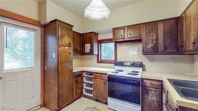 1811 Randolph Rd, Mogadore, OH 44260 - kitchen featuring white range with electric cooktop, backsplash, light countertops, and plenty of natural light