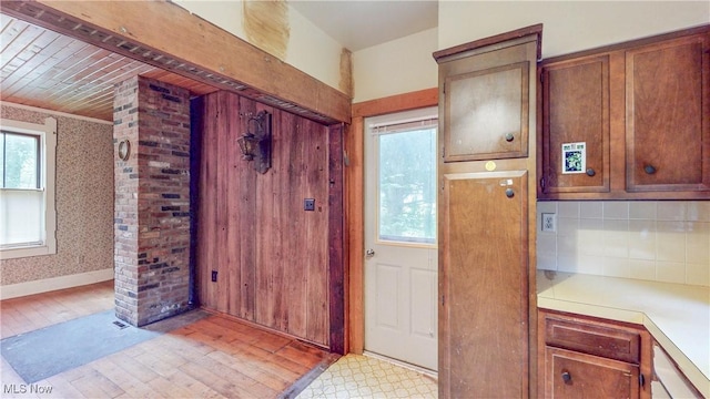 1811 Randolph Rd, Mogadore, OH 44260 - kitchen with light countertops, tasteful backsplash, brown cabinets, and light wood-style floors