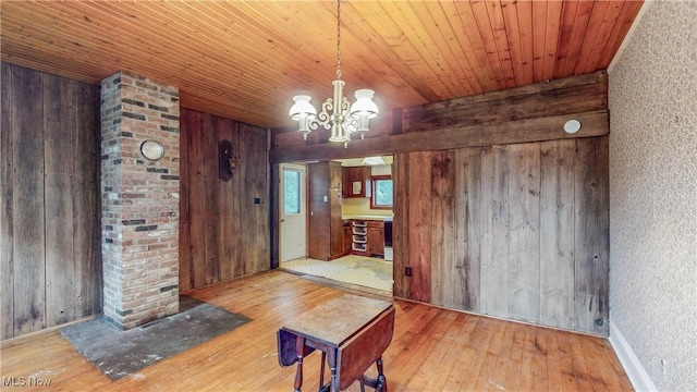 1811 Randolph Rd, Mogadore, OH 44260 - unfurnished dining area with wood-type flooring, wooden walls, wood ceiling, and a chandelier