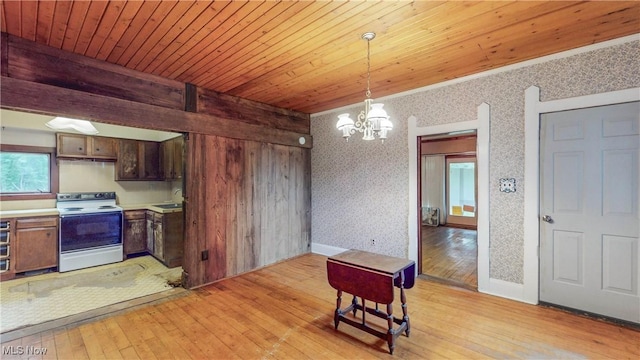 1811 Randolph Rd, Mogadore, OH 44260 - kitchen with white electric range oven, a chandelier, light wood-style floors, light countertops, and decorative light fixtures