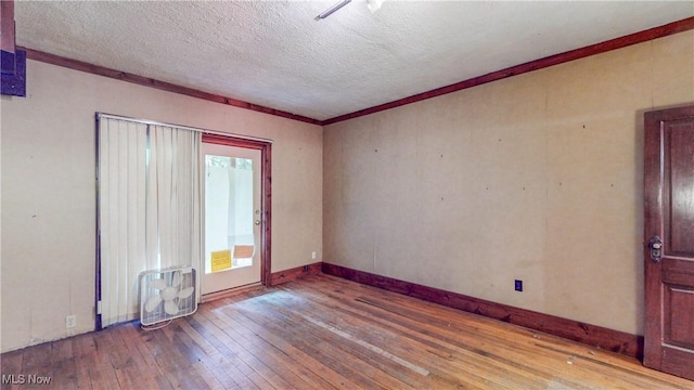 1811 Randolph Rd, Mogadore, OH 44260 - unfurnished room with hardwood / wood-style floors, a textured ceiling, and crown molding
