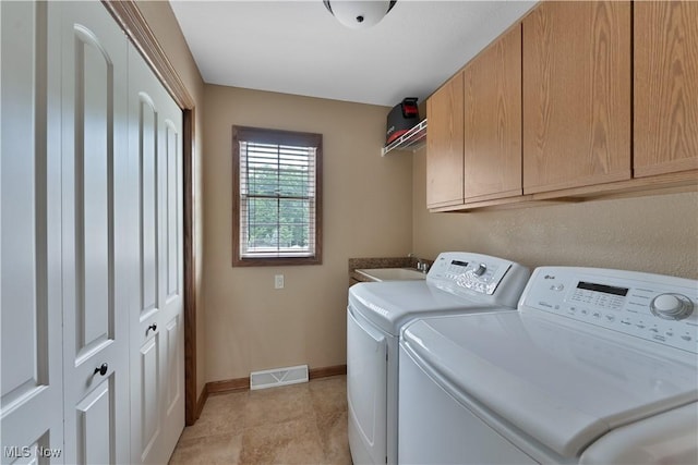 4053 Thats Life Ln, Canfield, OH 44406 - laundry room with cabinet space, washer and dryer, and light tile patterned floors