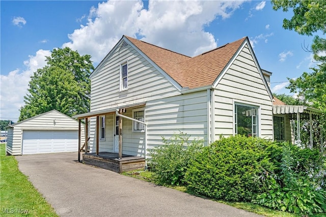 700 Alice St, East Palestine, OH 44413 - view of front of house with an outbuilding, a detached garage, and a shingled roof