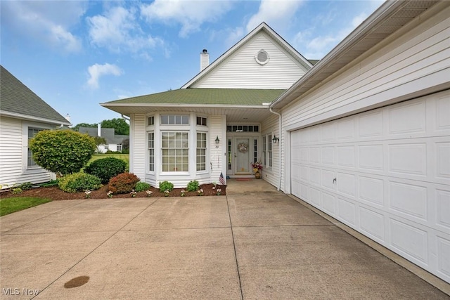 20 Golf View Ln, North Olmsted, OH 44070 - view of front of house with a chimney, driveway, and an attached garage
