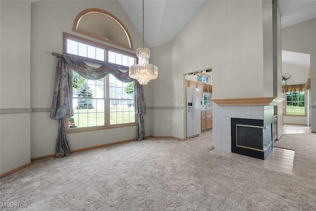 20 Golf View Ln, North Olmsted, OH 44070 - unfurnished living room featuring light colored carpet, a chandelier, healthy amount of natural light, and high vaulted ceiling