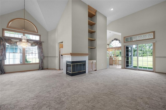 20 Golf View Ln, North Olmsted, OH 44070 - unfurnished living room featuring high vaulted ceiling, a chandelier, carpet, healthy amount of natural light, and a tiled fireplace