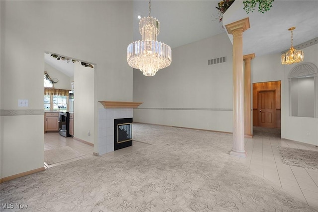 20 Golf View Ln, North Olmsted, OH 44070 - unfurnished living room with a chandelier, light tile patterned floors, a tiled fireplace, ornate columns, and a towering ceiling