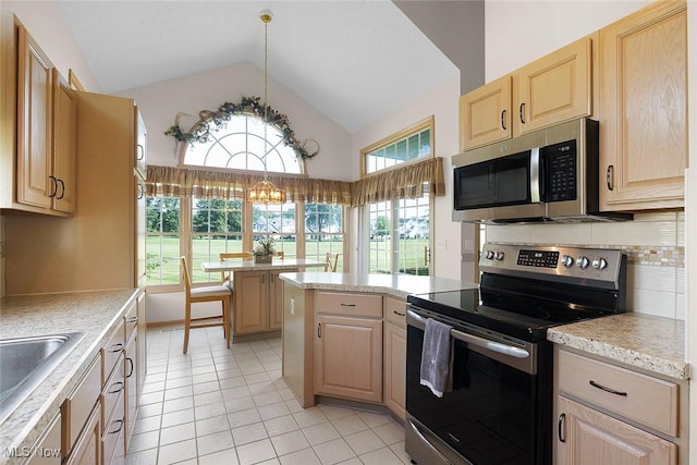 20 Golf View Ln, North Olmsted, OH 44070 - kitchen with appliances with stainless steel finishes, light brown cabinets, light countertops, light tile patterned floors, and a peninsula