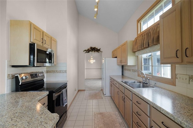 20 Golf View Ln, North Olmsted, OH 44070 - kitchen with stainless steel appliances, light brown cabinets, high vaulted ceiling, decorative backsplash, and light tile patterned floors