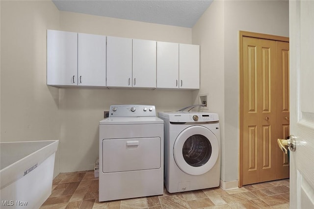 20 Golf View Ln, North Olmsted, OH 44070 - washroom featuring cabinet space, washing machine and clothes dryer, and stone finish flooring