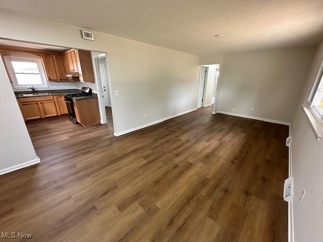 30115 Regent Rd, Wickliffe, OH 44092 - kitchen featuring gas stove, dark countertops, open floor plan, and healthy amount of natural light