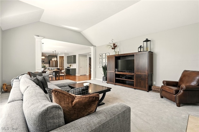 10421 Tolland Dr, Reminderville, OH 44202 - living room with decorative columns, lofted ceiling, light colored carpet, and a chandelier