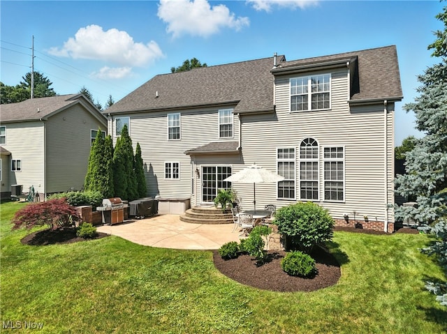 10421 Tolland Dr, Reminderville, OH 44202 - back of property featuring a patio, a yard, and a shingled roof