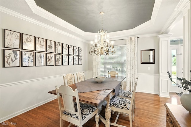 10421 Tolland Dr, Reminderville, OH 44202 - dining space featuring a raised ceiling, wood finished floors, a chandelier, and ornamental molding