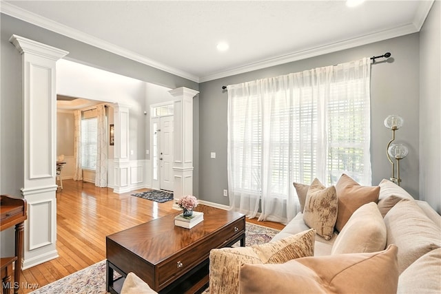 10421 Tolland Dr, Reminderville, OH 44202 - living area with decorative columns, ornamental molding, light wood-type flooring, recessed lighting, and a wainscoted wall