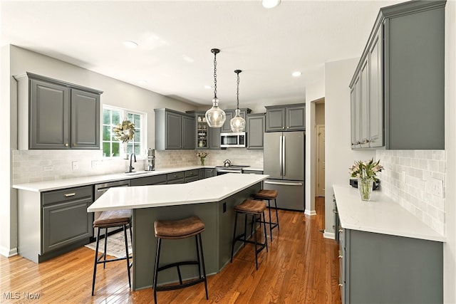 10421 Tolland Dr, Reminderville, OH 44202 - kitchen with appliances with stainless steel finishes, gray cabinetry, tasteful backsplash, and recessed lighting