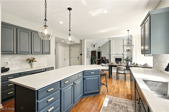 10421 Tolland Dr, Reminderville, OH 44202 - kitchen with a kitchen island, recessed lighting, decorative backsplash, light wood-style floors, and open floor plan