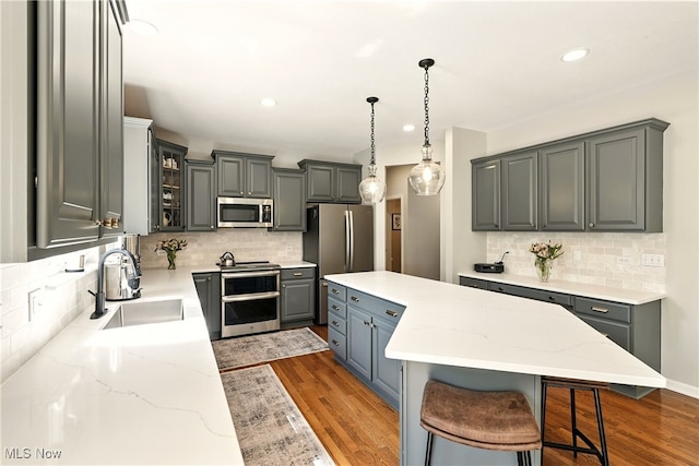 10421 Tolland Dr, Reminderville, OH 44202 - kitchen featuring stainless steel appliances, gray cabinetry, tasteful backsplash, and recessed lighting