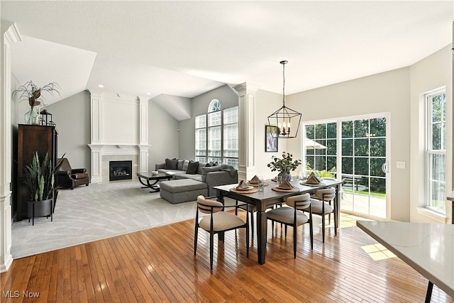 10421 Tolland Dr, Reminderville, OH 44202 - dining area with wood-type flooring, plenty of natural light, a large fireplace, and lofted ceiling
