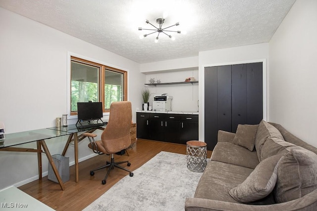 4280 Som Center Rd, Moreland Hills, OH 44022 - office with a chandelier, wood finished floors, and a textured ceiling