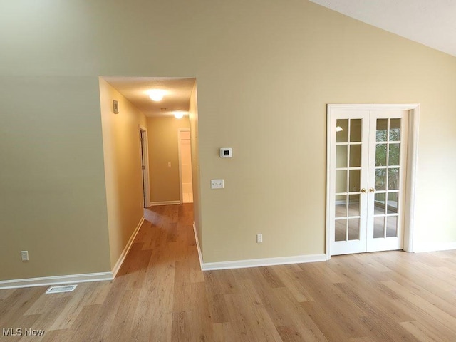422 Dartmouth Trl, Sagamore Hills, OH 44067 - empty room with light wood-type flooring, french doors, and vaulted ceiling