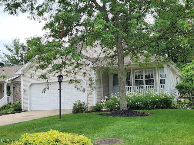 422 Dartmouth Trl, Sagamore Hills, OH 44067 - view of front of house with covered porch, a front lawn, driveway, and an attached garage