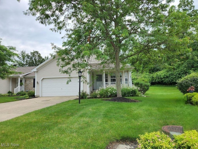 422 Dartmouth Trl, Sagamore Hills, OH 44067 - view of front of house featuring a front yard, an attached garage, concrete driveway, and a porch