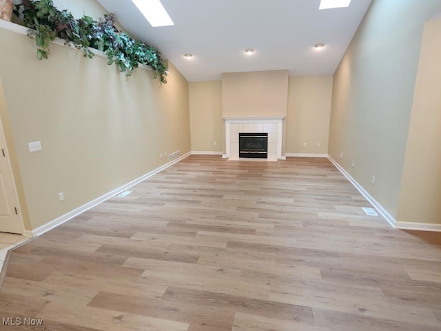 422 Dartmouth Trl, Sagamore Hills, OH 44067 - unfurnished living room featuring light wood finished floors, a tile fireplace, and recessed lighting