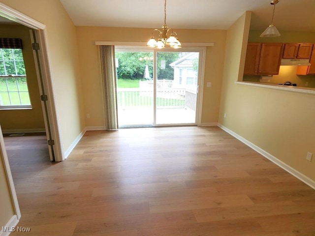 422 Dartmouth Trl, Sagamore Hills, OH 44067 - unfurnished dining area featuring light wood-type flooring and a chandelier