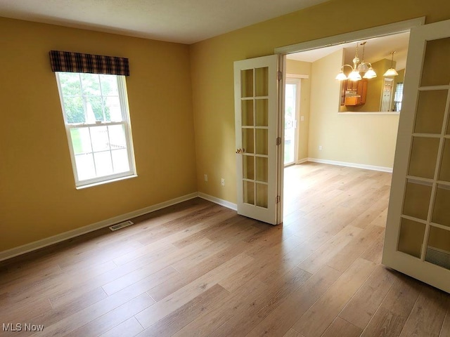 422 Dartmouth Trl, Sagamore Hills, OH 44067 - empty room featuring a chandelier, wood finished floors, and french doors