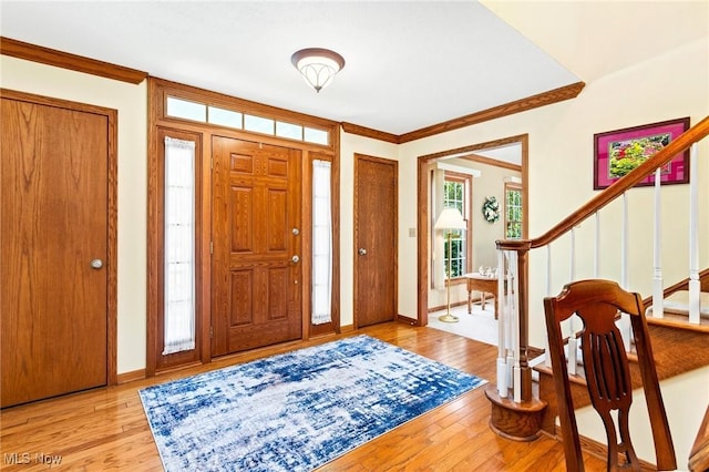 302 Brookpoint Cir, Wadsworth, OH 44281 - entrance foyer with stairs, light wood-style floors, and ornamental molding
