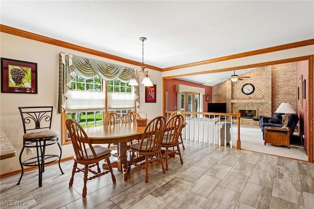 302 Brookpoint Cir, Wadsworth, OH 44281 - dining area featuring a brick fireplace, ornamental molding, and vaulted ceiling