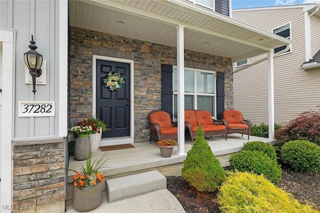 37282 Amber Way N, Ridgeville, OH 44039 - view of exterior entry featuring a porch and stone siding