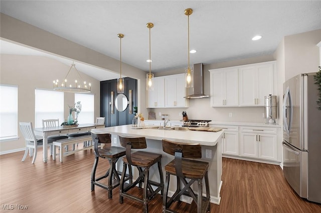 37282 Amber Way N, Ridgeville, OH 44039 - kitchen with freestanding refrigerator, wall chimney range hood, dark wood-style floors, light countertops, and vaulted ceiling