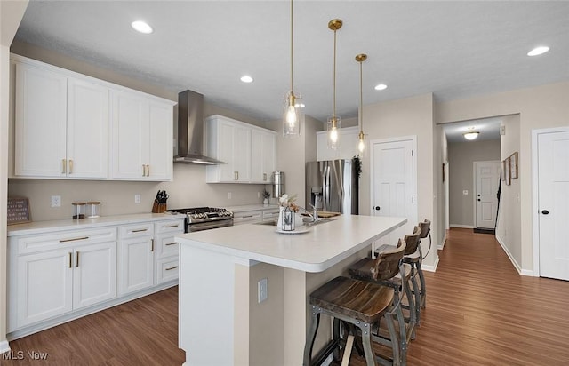37282 Amber Way N, Ridgeville, OH 44039 - kitchen featuring wall chimney range hood, stainless steel appliances, dark wood-style flooring, white cabinetry, and light countertops