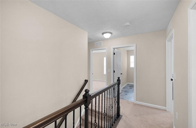 37282 Amber Way N, Ridgeville, OH 44039 - hallway with an upstairs landing, a textured ceiling, and light carpet