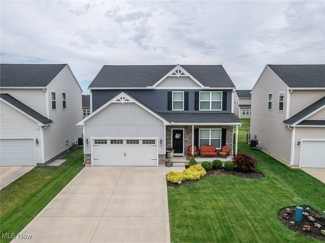 37282 Amber Way N, Ridgeville, OH 44039 - craftsman-style home featuring board and batten siding, a porch, concrete driveway, and stone siding