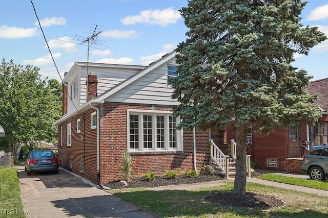 5902 Vandalia Ave, Cleveland, OH 44144 - view of front facade with brick siding and concrete driveway