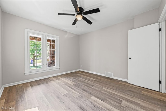 5902 Vandalia Ave, Cleveland, OH 44144 - empty room with wood finished floors and ceiling fan