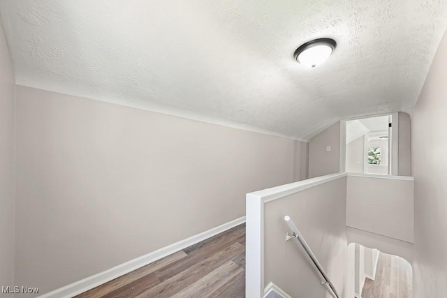 5902 Vandalia Ave, Cleveland, OH 44144 - additional living space featuring a textured ceiling, wood finished floors, and lofted ceiling