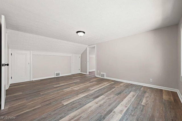 5902 Vandalia Ave, Cleveland, OH 44144 - additional living space with wood finished floors, lofted ceiling, and a textured ceiling