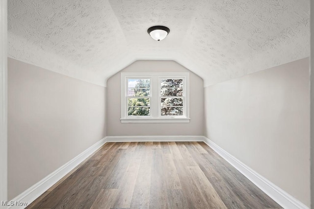 5902 Vandalia Ave, Cleveland, OH 44144 - bonus room with a textured ceiling, wood finished floors, and vaulted ceiling