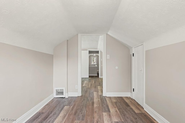 5902 Vandalia Ave, Cleveland, OH 44144 - additional living space with a textured ceiling, wood finished floors, and lofted ceiling