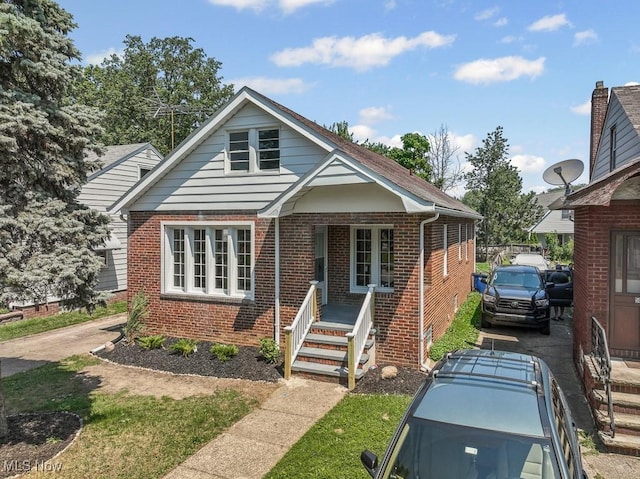 5902 Vandalia Ave, Cleveland, OH 44144 - bungalow featuring brick siding and covered porch