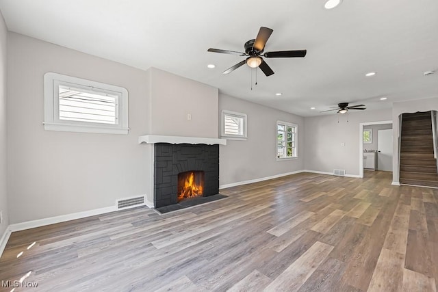 5902 Vandalia Ave, Cleveland, OH 44144 - unfurnished living room featuring wood finished floors, recessed lighting, ceiling fan, stairs, and a fireplace