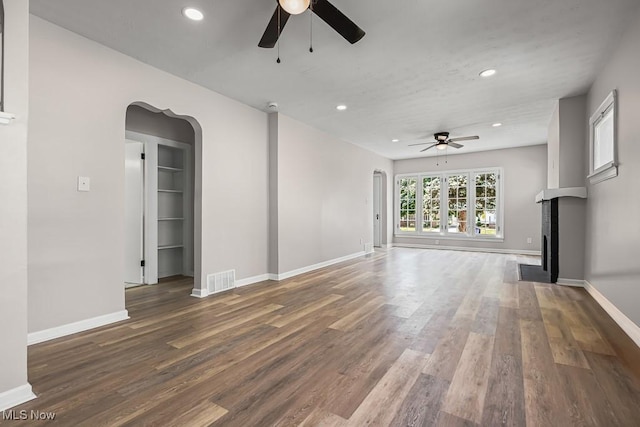 5902 Vandalia Ave, Cleveland, OH 44144 - unfurnished living room with a ceiling fan, arched walkways, recessed lighting, wood finished floors, and a fireplace with flush hearth